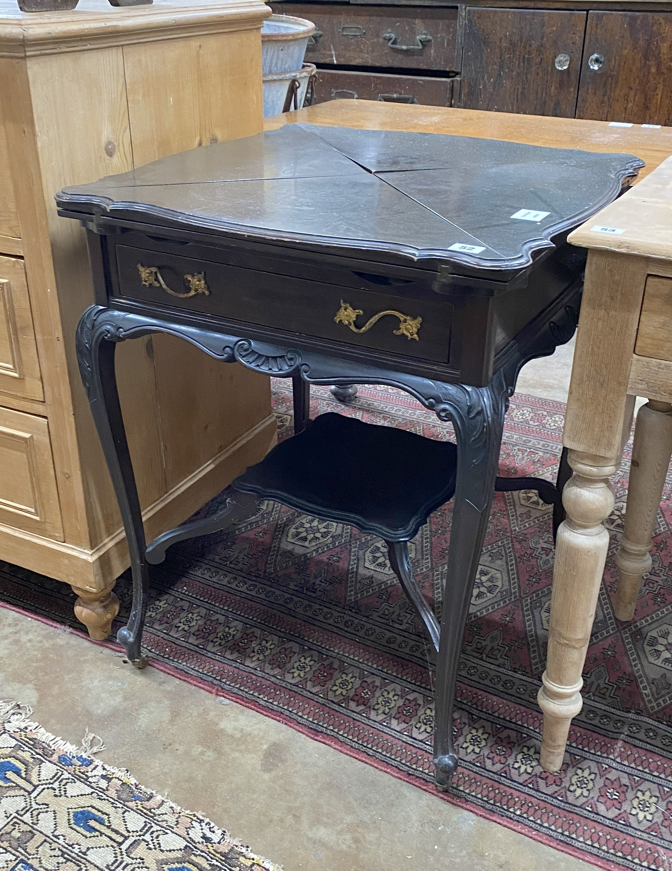 An Edwardian ebonised envelope card table, width 58cm height 74cm